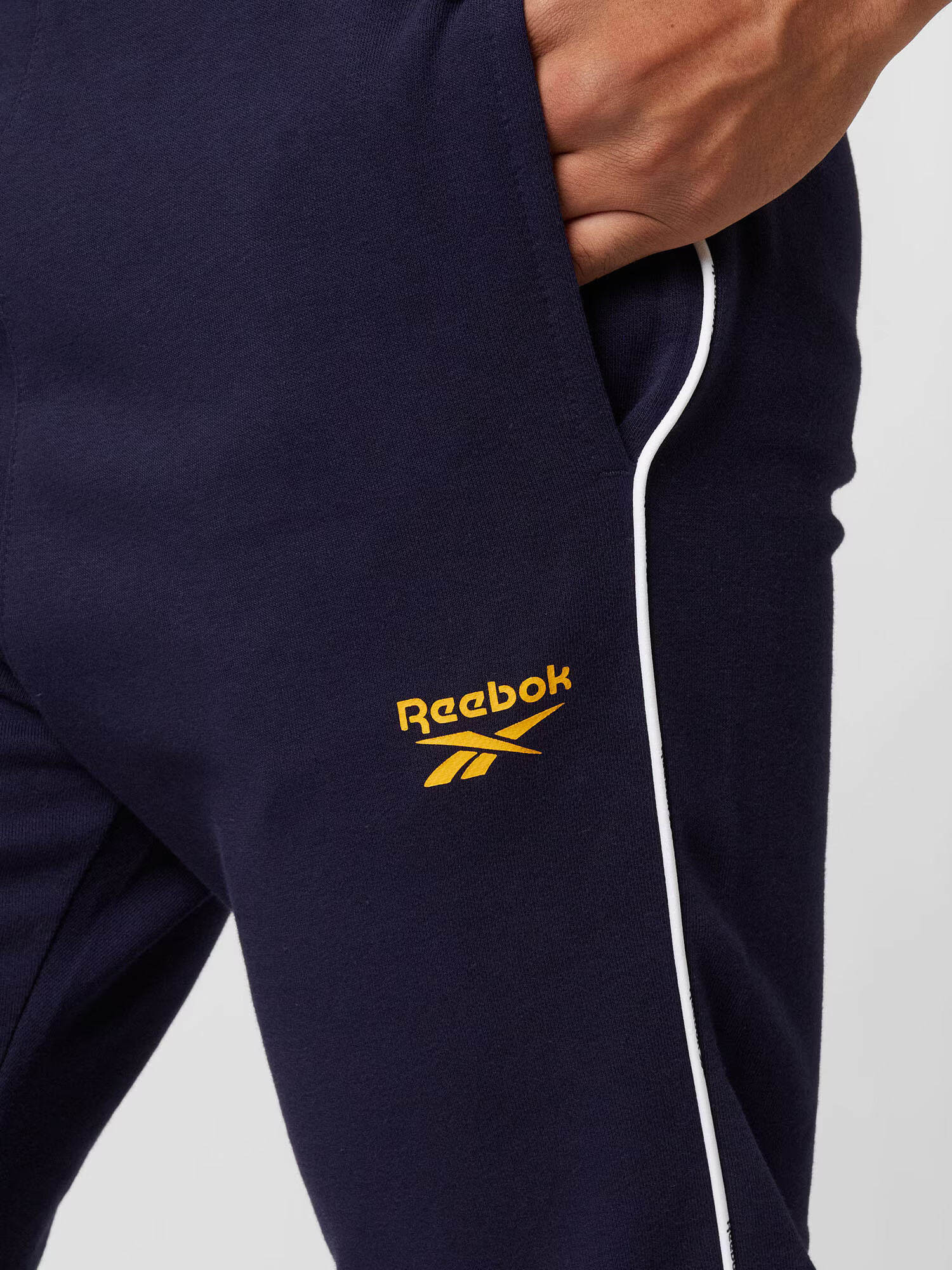 Reebok Sport Športové nohavice námornícka modrá / tmavožltá / biela - Pepit.sk