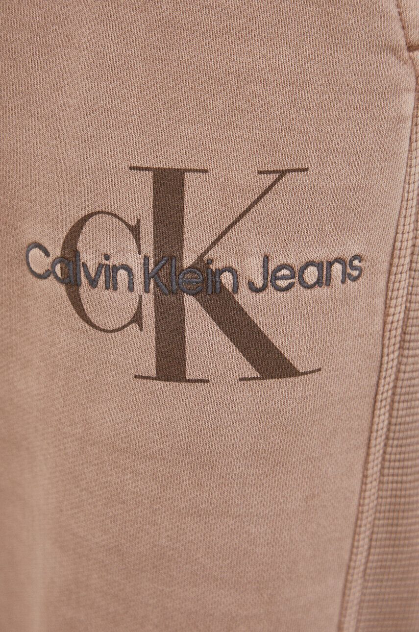 Calvin Klein Jeans Bavlnené tepláky béžová farba jednofarebné - Pepit.sk